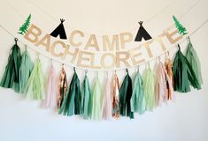 some tassels are hanging from a string with the word camp pelecote on it