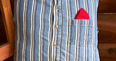 a man's shirt with a red heart in the pocket