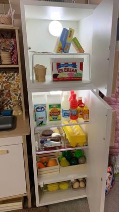 an open refrigerator filled with lots of food and condiments on top of it