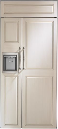 a white refrigerator freezer sitting inside of a wooden kitchen cabinet with an ice dispenser on the door