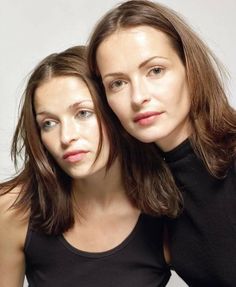 two women are posing for the camera with their arms around each other's shoulders