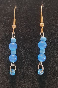 "Blue dangle earrings with hooks. Multi shades and sizes of blue. Approx 2\" long." Turquoise Dangle Jewelry With French Hook, Blue Round Beads Earrings For Jewelry Making, Blue Hypoallergenic Beaded Earrings As Gift, Hypoallergenic Blue Beaded Earrings For Gift, Handmade Blue Round Bead Earrings, Blue Dangle Hoop Earrings, Handmade Light Blue Dangle Earrings, Handmade Blue Dangle Earrings, Handmade Blue Teardrop Crystal Earrings