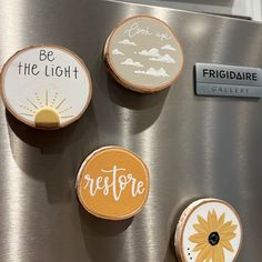 four magnets on the side of a refrigerator