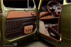 the interior of a green car with brown leather trim