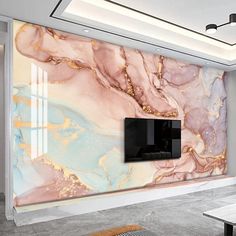 a living room with marbled walls and a flat screen tv mounted on the wall