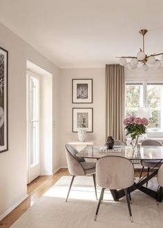 a dining room table with four chairs and a chandelier hanging from the ceiling