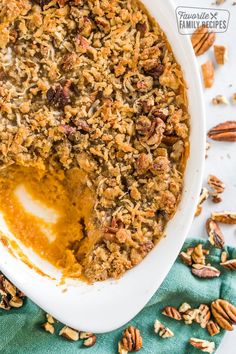 a close up of a bowl of food with pecans around it