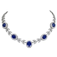 A stylish necklace showcasing five oval cut diamonds set in a flower design halo made of diamonds. Each sapphire halo is spaced by diamond leaves. Made in 18k white gold. Sapphires weigh 20.65 carats total. Diamonds weigh 8.50 carats total. 16.5 inches in length. 0.66 inches in maximum width. 1stdibs Necklace, Saphire Jewelry, 1stdibs Jewelry, Blue Diamond Necklace, Goth Wardrobe, Blue Diamond Jewelry, Ruby And Diamond Necklace, Goddess Aesthetic, The Bling Ring