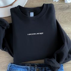 🌟 Looking for a unique gift idea? Our Custom Embroidered Sweatshirt is the perfect choice! 🎁 Personalize it with your favorite text or design for a heartfelt touch. Whether you're celebrating a birthday, anniversary, or just want to show some love, this sweatshirt is a cozy and stylish way to do it. Handcrafted with care, it's a personalized gift she'll cherish forever. Treat yourself or surprise someone special today! ✨ A sturdy and warm sweatshirt bound to keep you warm in the colder months. Black Crew Neck Sweatshirt For Gift, Crew Neck Slogan Sweatshirt As Gift, Crew Neck Top With Embroidered Text As Gift, Custom Embroidered Sweatshirt, Text Gift, Personalized Logo, Sister Wife, Logo Shirt, For Her Gifts