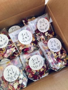 a cardboard box filled with lots of different types of dried flowers and labels on them