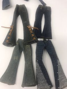 four pairs of jeans with laces on them are laying next to each other and tied together