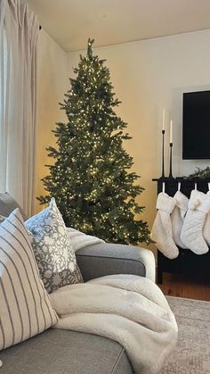 a living room with a christmas tree in the corner