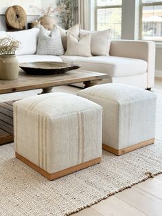 a living room filled with furniture and a wooden table in front of a white couch