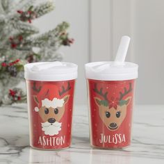 two christmas cups with reindeer faces on them