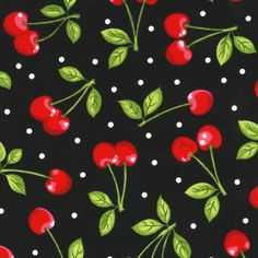 a black background with red cherries and green leaves on polka dotty cotton fabric