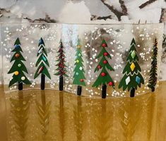 a glass block with christmas trees painted on it