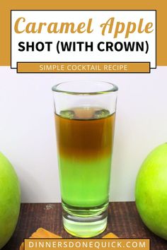 caramel apple shot with crown in front of two green apples