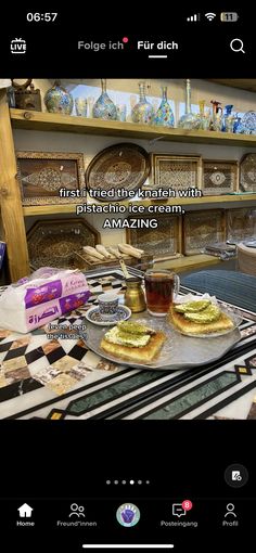 a table topped with lots of food next to a shelf filled with plates and bowls