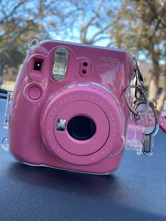 a pink camera sitting on top of a table