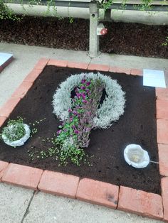 a flower arrangement is placed on the ground