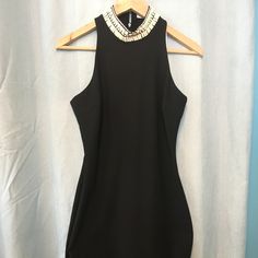 A High, Bead-Embellished Neckline Frames The Face Atop An Elegant Figure-Skimming Dress Cut To Showcase The Shoulders. 40" Length (Size 8). Back Zip Closure. Stretch Lining. 54% Polyester, 38% Viscose Rayon, 8% Elastane. Dry Clean. Chic Party Dress With Embellished Collar, Chic Stretch Embellished Bodycon Dress, Fitted Party Dress With Embellished Collar, Elegant Stretch Embellished Mini Dress, Fitted Embellished Sleeveless Mini Dress, Glamorous Beaded Sleeveless Mini Dress, Fitted Embellished Halter Neck Mini Dress, Beaded Sleeveless Dresses For Party Season, Formal Beaded Mini Dress