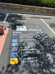 a parking lot with chalk writing on it