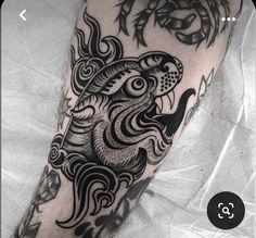 a black and white photo of a tattoo on the leg