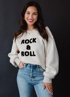 If you loved our Rock & Roll sweaters, then you're going to love this new sweatshirt! Our tan and black oversized sweatshirt with textured "Rock & Roll" text on the front is a must have to add to your closet.  Tan oversized sweatshirt Black "Rock & Roll" textured text on the front Long sleeves Designed in the U.S.A. Produced in China.  Model is wearing a size small  60% Polyester / 40% Cotton SIZE CHART S: Bust: 38" / Length: 24" M: Bust: 40" / Length: 25" L: Bust: 42" / Length: 26" XL: Bust: 44 Oversized Casual Sweatshirt For Concerts, Fall Band Merch Sweatshirt With Text Print, Oversized Band Merch Sweatshirt For Fall, Fall Concert Sweatshirt With Letter Print, Letter Print Sweatshirt For Concerts In Fall, Letter Print Sweatshirt For Fall Concerts, Trendy Relaxed Fit Sweatshirt For Concert, Relaxed Fit Long Sleeve Sweatshirt For Concerts, Long Sleeve Relaxed Fit Sweatshirt For Concerts