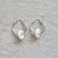 Puka Shell Hoop Earrings~ Beautiful Hawaiian puka shells adorn small tube hoops. Great gift for the beach lover! Hoops 2 X 18mm. Choose 14k gold fill, rose gold fill or sterling silver from the drop down menu. Models wearing similar designs. Shop~ http://www.etsy.com/shop/HanaMauiCreations?ref=pr_shop_more International buyers please read our shipping policies before ordering~ POLICIES~ https://www.etsy.com/shop/HanaMauiCreations/policy?ref=shopinfo_policies_leftnav Nickel-free White Huggie Earrings, White Nickel-free Huggie Hoop Earrings, Nickel-free White Small Hoop Huggie Earrings, Adjustable Nickel-free White Hoop Earrings, White Nickel-free Small Hoop Huggie Earrings, Adjustable White Nickel Free Hoop Earrings, White Hypoallergenic Huggie Hoop Earrings, White Small Hoop Huggie Earrings As A Gift, White Small Hoop Huggie Earring