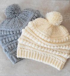 two crocheted hats sitting next to each other