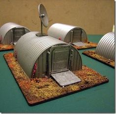 three tin can houses sitting on top of a table