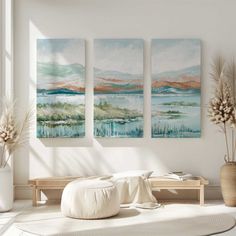 three paintings hanging on the wall in a living room