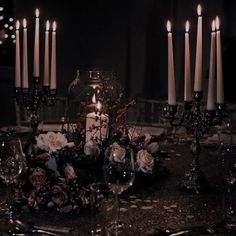 a table topped with lots of candles and flowers