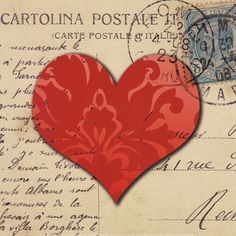 a red heart on top of an old postcard