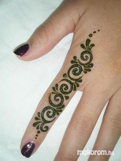 a woman's hand with a henna tattoo on it