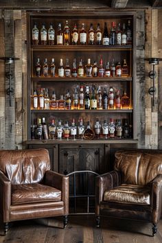 two leather chairs sitting next to each other in front of a shelf filled with bottles