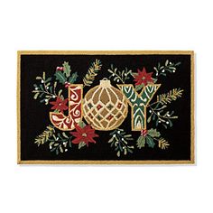 a black and gold christmas door mat with ornaments on the front, one or both sides