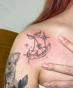 a woman with a tattoo on her shoulder