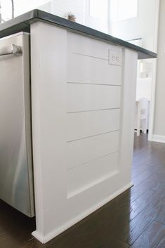 a kitchen with a dishwasher, sink and counter top that is painted white