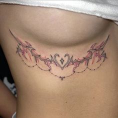 a woman's lower back tattoo with hearts and vines on her side ribcage