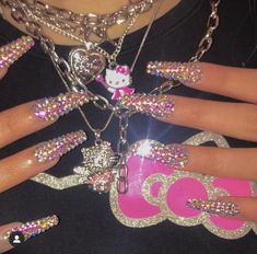 a woman with hello kitty nail art on her nails and holding onto a pink purse