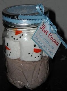 a glass jar filled with lots of white frosted marshmallows sitting on top of a table