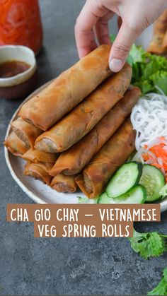 vietnamese spring rolls on a plate with dipping sauce