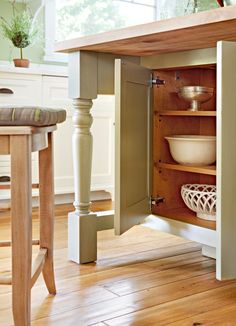 an open cabinet in the middle of a kitchen