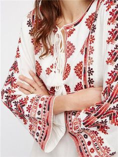 Main Composition: Cotton Pattern :Floral Element: Embroidery, Fringe Style: Boho & Vacation Fit: Loose Fabric: Cotton Neckline: Tie Neck Sleeve Type: Regular Sleeve Length: Long Sleeve Product Type: A-Line Dress Occasion: Vacation Dress/Skirt Length: Short Season: Spring/Fall Bohemian Embroidered Top With Geometric Design For Vacation, Bohemian Embroidered Hem Top For Beach, Embroidered Top For Vacation In Fall, Folk Style Embroidered Top For Vacation, Bohemian Embroidered Top With Multicolor Floral Design, Bohemian Embroidered Top With Multicolor Floral Embroidery, Bohemian Multicolor Floral Embroidered Top, Peasant Festival Top With Embroidered Hem, Bohemian Embroidered Top For Beach