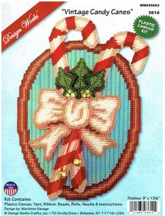 a cross stitch christmas ornament with candy canes