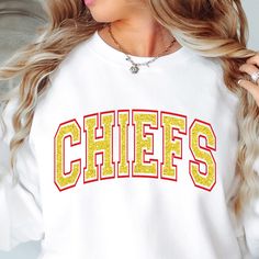 Chiefs Crew sweatshirt, off shoulder Chiefs sweatshirt, Chiefs shirt, Chiefs football, Chiefs basketball, Chiefs baseball LOGO: (red vinyl-yellow glitter) You will love this super cute, soft and comfy sweatshirt while you celebrate your favorite team! This style is a unisex style so they do run larger and are meant to be a bit baggy. ► SUPERBOWL SHIPPING CHART (please select correct shipping) Order by Tuesday, January 21st - Regular Ground Shipping to receive by Friday 31st. Order by Friday, Jan Chiefs Sweatshirt Women, Varsity Tops For Cheerleading During Football Season, Varsity Tops For Cheerleading, Football Season, Varsity Style Top For Cheerleading And Football Season, Crew Neck Top With Team Logo For Cheerleading, Yellow Tops With Letter Print For Sports Season, Yellow Tops For Sports Events, Yellow Tops With Letter Print For Sports Events, Glitter Print Tops For Sports Events And Season