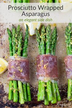 asparagus wrapped in prosciutto on a baking sheet