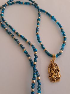 Waistbeads, made with 4mm blue and gold glass seed beads,6mm Czech glass beads,and gold plated 'Ganesha' charm,the Hindu deity of removing obstacles. Beads are on heavy elastic cord. Wrap 4 times for bracelets,3 times for anklets,and open for necklace. Spiritual Round Waist Beads As A Gift, Spiritual Style Waist Beads As A Gift, Gold Mala With 108 Beads For Healing, Spiritual Style Waist Beads For Gift, Gold Healing Mala With 108 Beads, Gold Mala With Round Beads For Healing, Spiritual Waist Beads For Meditation, Gold Spiritual Mala For Healing, Gold Hand-strung Mala For Meditation