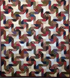 a quilt made with different colors and shapes